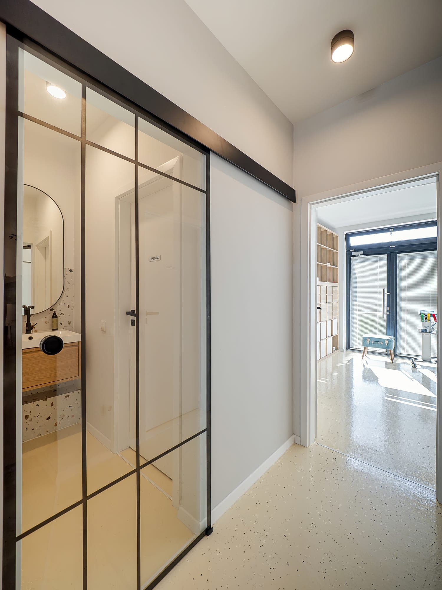 The Biocord hallway, with sliding glass doors and the bright consulting room at the end
