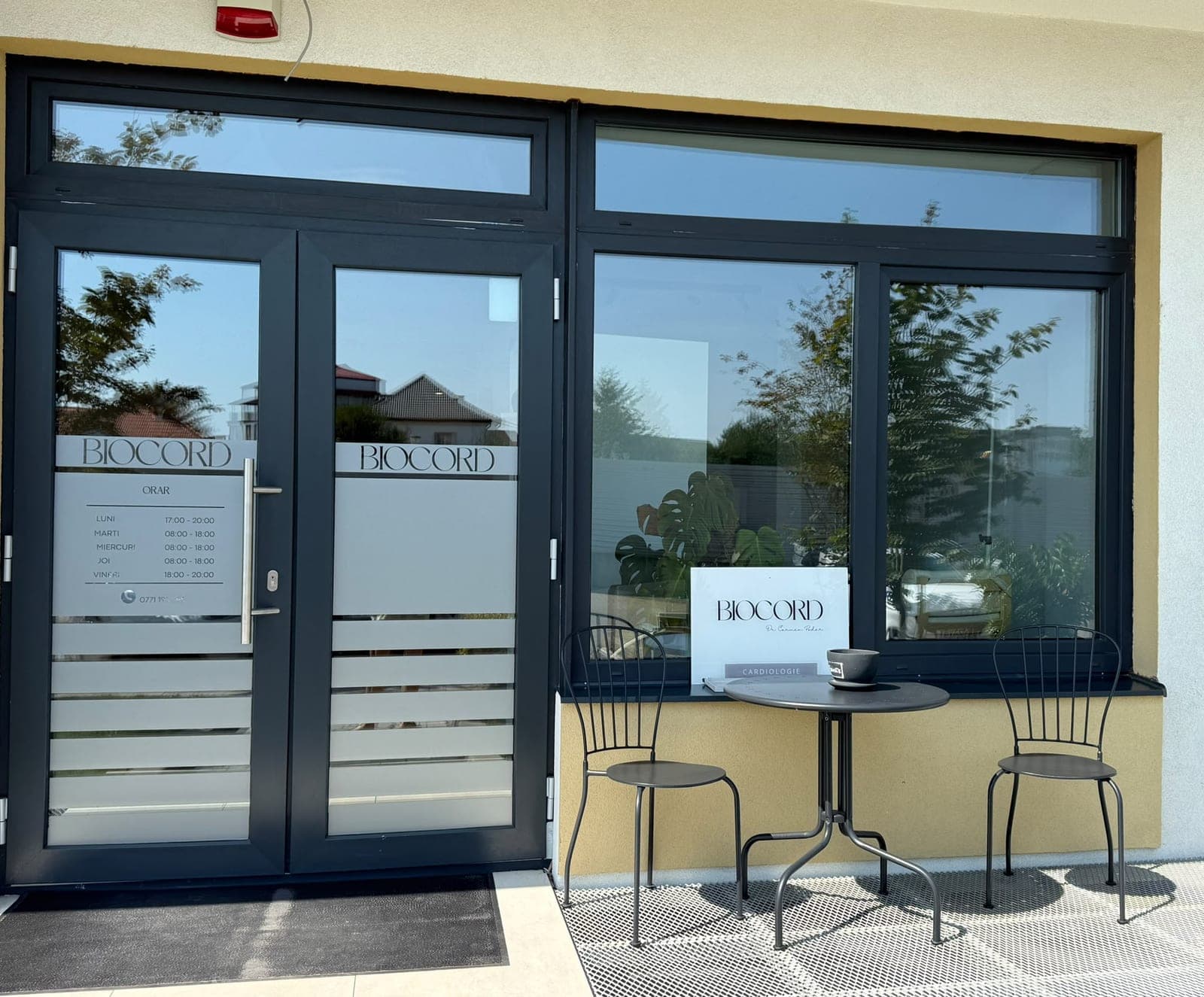 The entrance to the Biocord practice, a lettered glass door with a small table and chairs outside